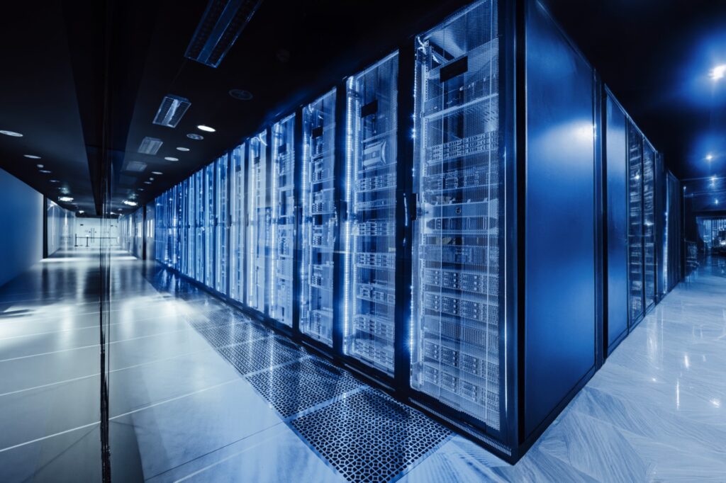Rows of server racks in a blue-lit data centre